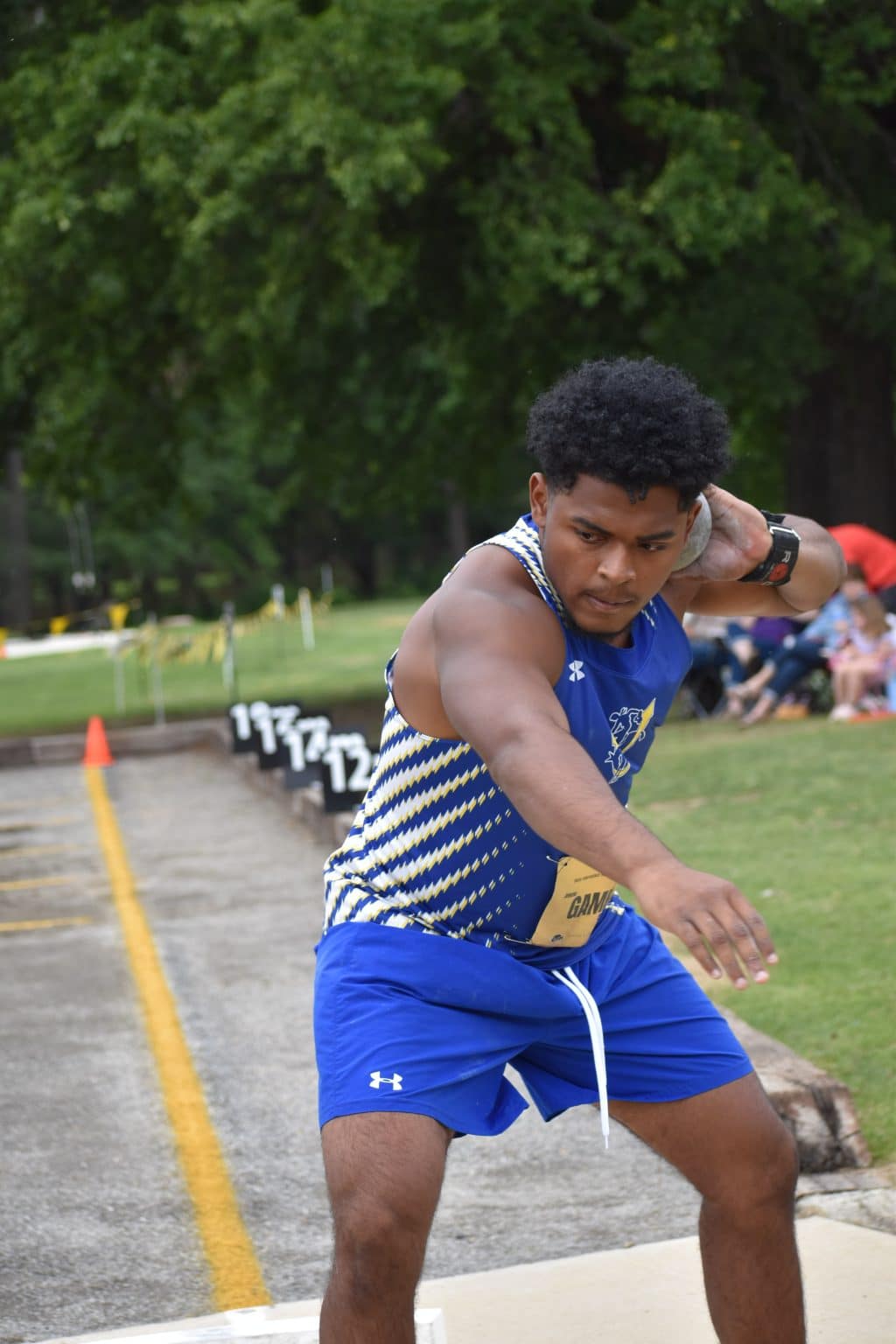 A Mulerider thrower in a blue SAU uniform spins in the throwing circle